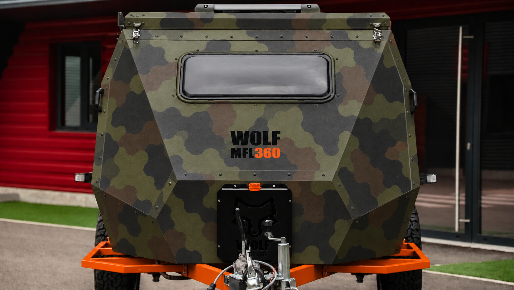Front view of WOLF MFL 360 caravan in army camouflage, roof closed.