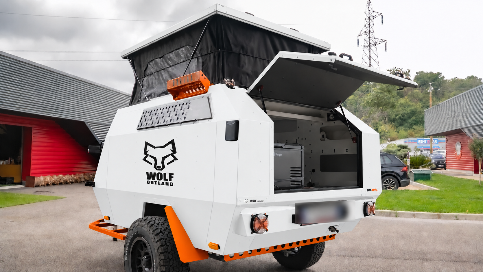 Rear three-quarter view · left side of WOLF MFL 360 caravan in glacier white, roof raised · kitchen open.