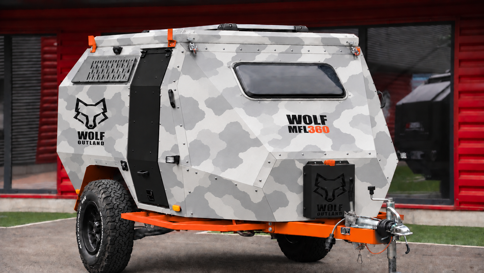 Front three-quarter view · right side of WOLF MFL 360 caravan in light snow camouflage, roof closed · door closed.