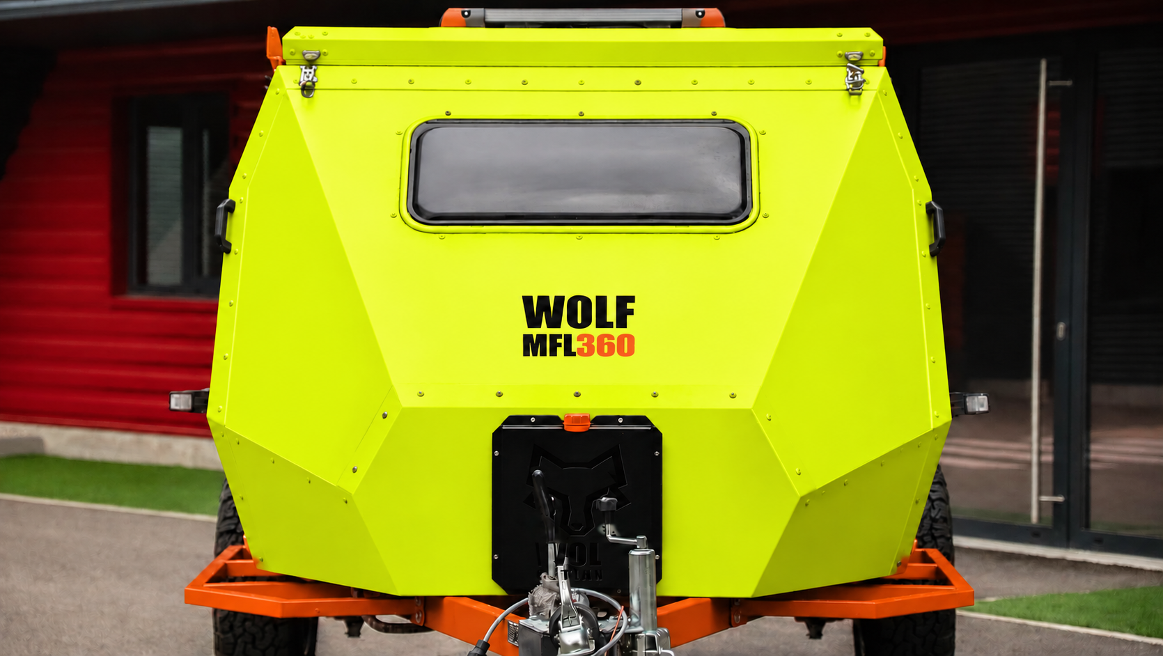 Front view of WOLF MFL 360 caravan in fluorescent yellow, roof closed.