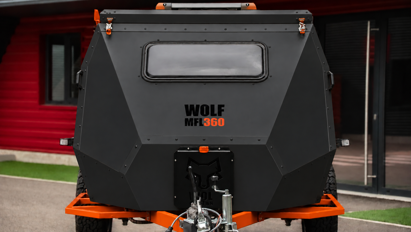 Front view of WOLF MFL 360 caravan in matt black, roof closed.