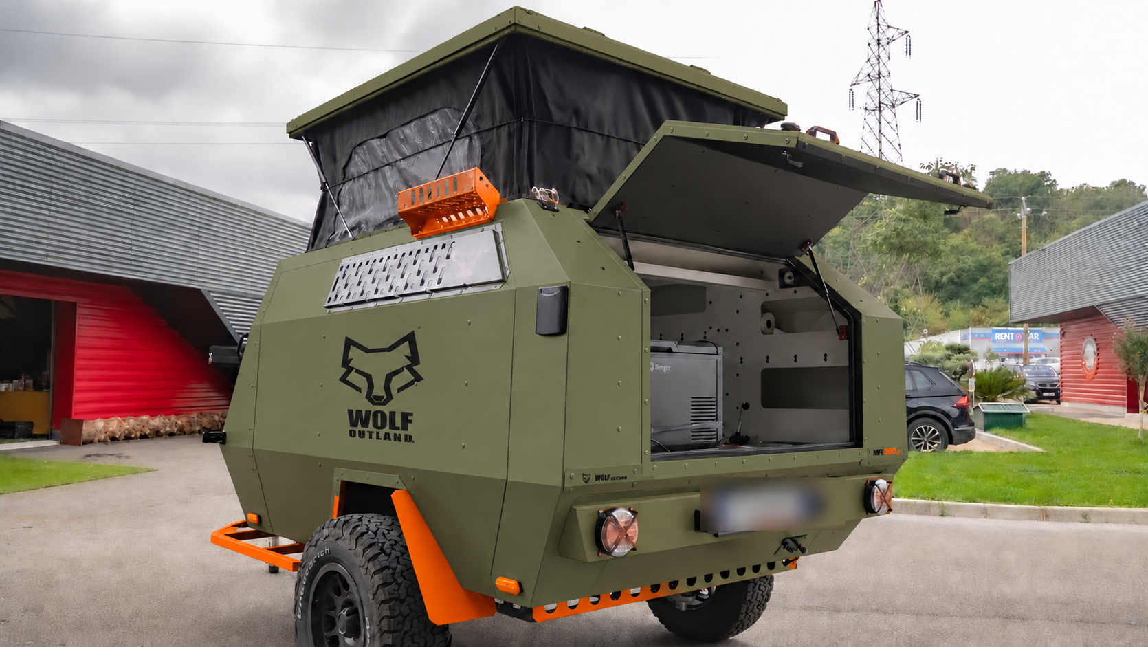 Rear three-quarter view · left side of WOLF MFL 360 caravan in tactical olive, roof raised · kitchen open.