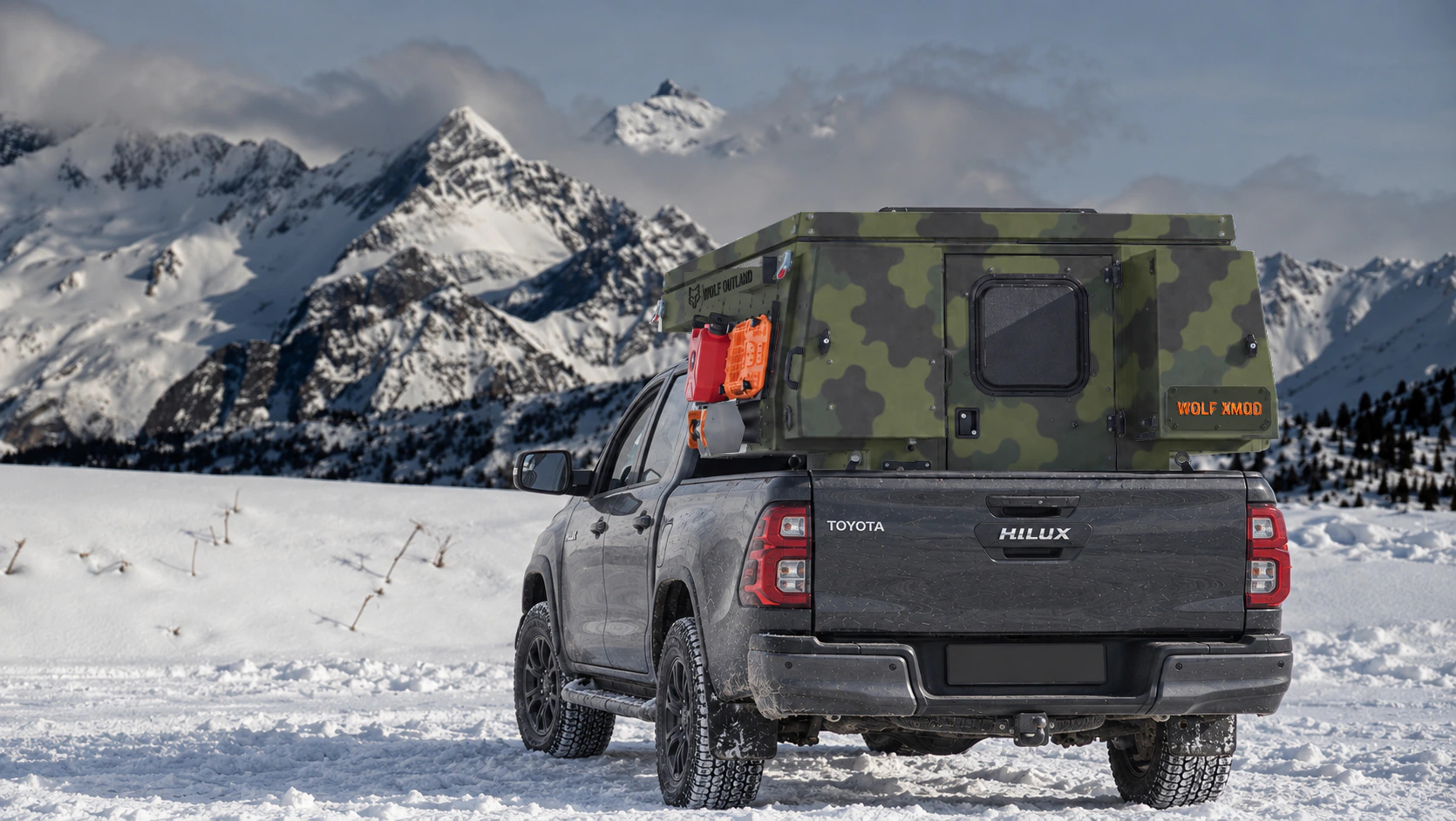 Toyota Hilux in anthracite grey with WOLF XMOD in Army camouflage, two solid rear cabinets — Rear view, roof closed, Orange backlit WOLF XMOD plate.