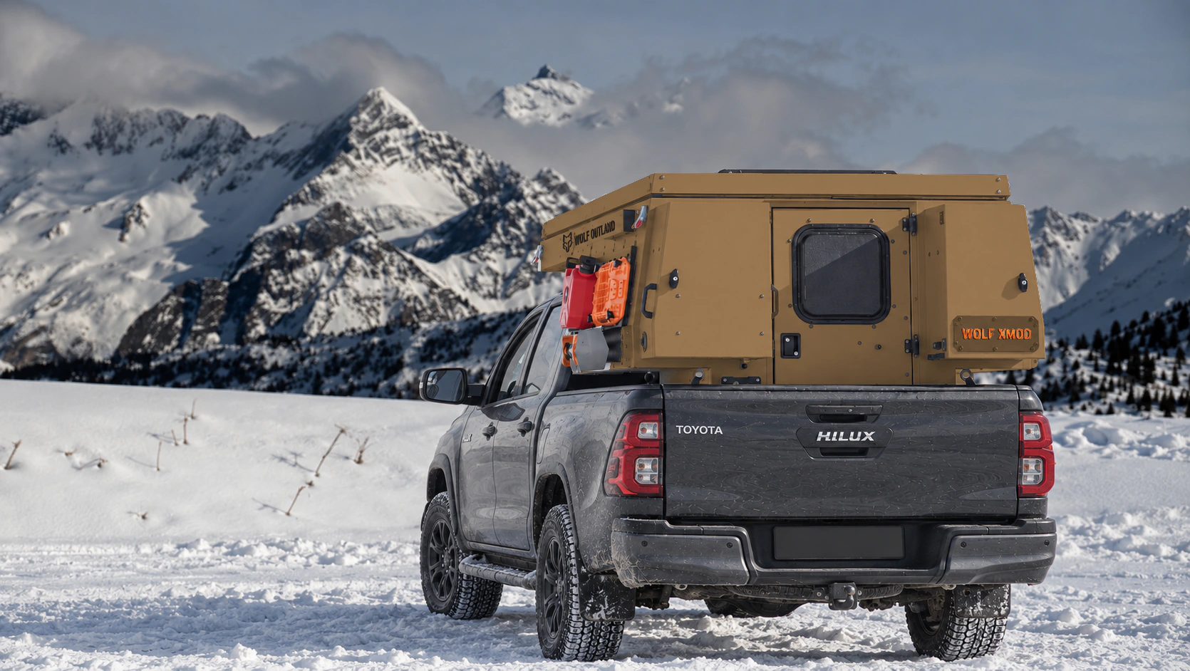 Toyota Hilux in anthracite grey with WOLF XMOD in Bronze, two solid rear cabinets — Rear view, roof closed, Orange backlit WOLF XMOD plate.